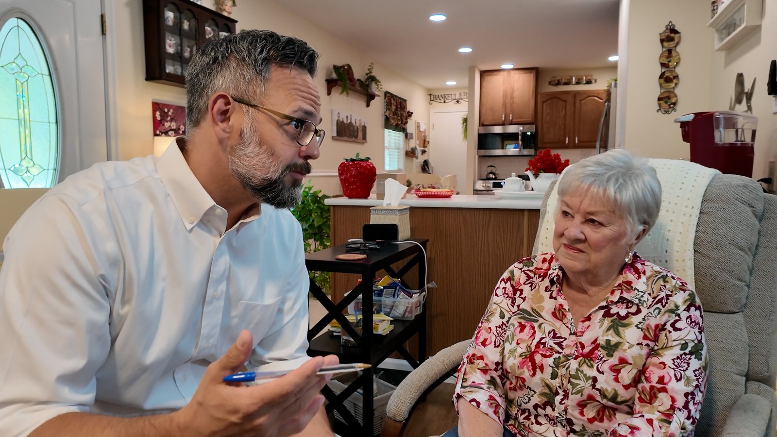 Phil Castaneda talking with a homeowner during a walkthrough