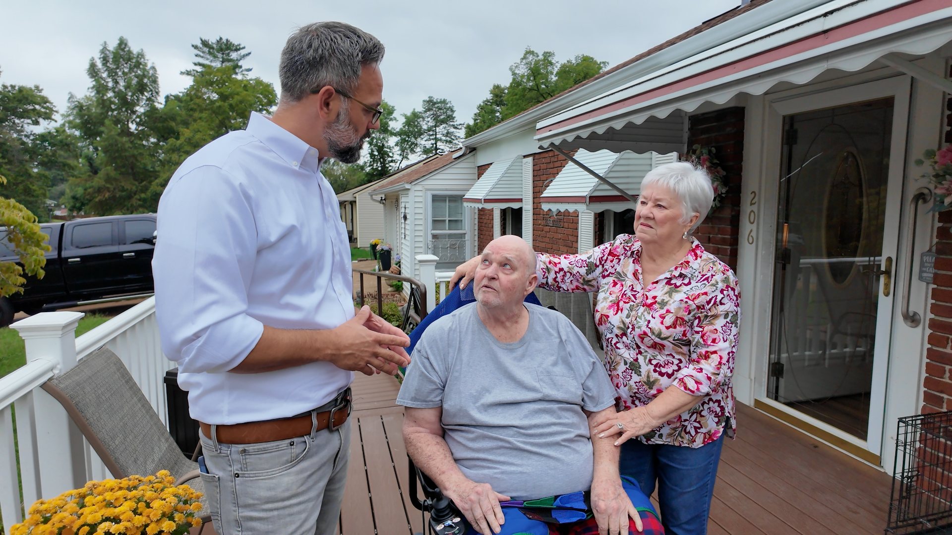 Phil Castaneda meeting with homeowners on their front porch in St. Louis