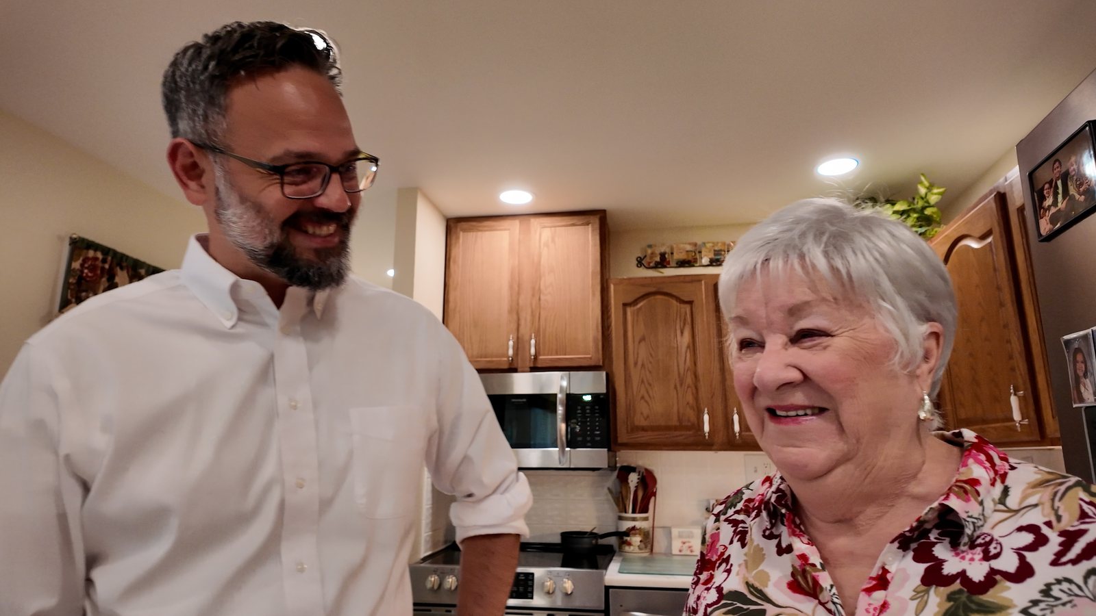 Phil Castaneda talking with a homeowner in her kitchen
